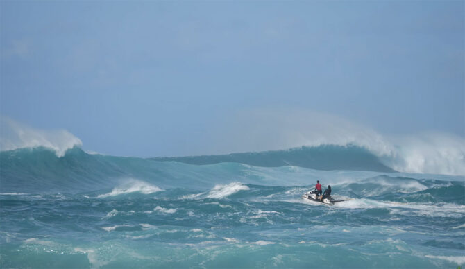 Ben Gravy riding a jetski out to an outer reef on the North Shore of Oahu