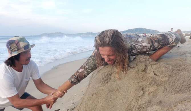 Blair Conklin attempting to reset his shoulder dislocation on a beach in Mexico