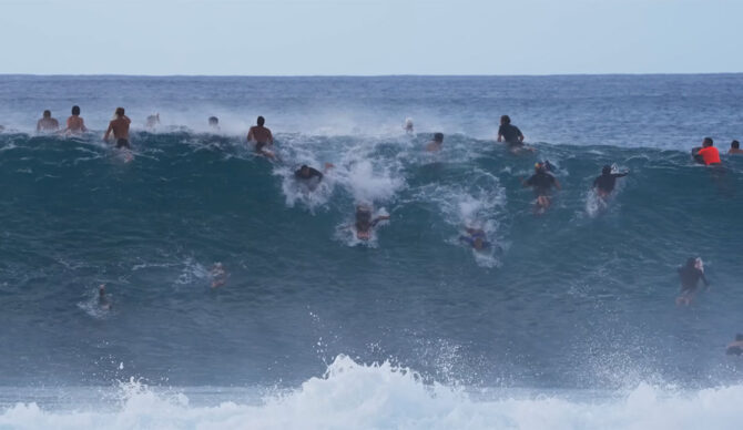 Jamie O'Brien surfing Pipeline in a big crowd