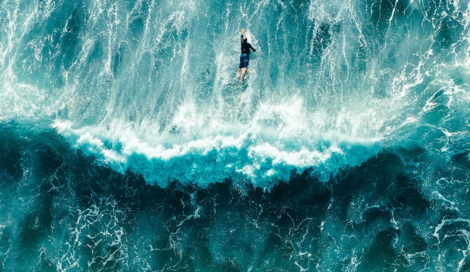 man paddling over waves like microscopic particles do