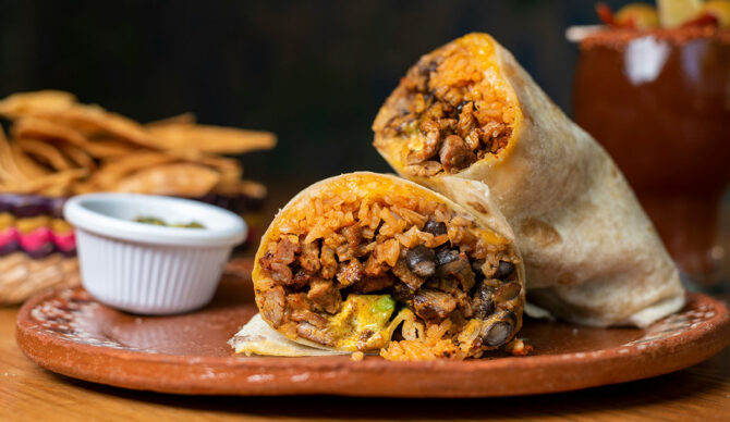 Surfers, like any group of people who share a common way of life, get wrapped up in a neatly bundled stereotype. Hollywood did the honors of giving us an image that stuck: longhaired, sunkissed beat generation types who smoke pot and live on the edge of society, contributing little more than good looks and a communal style of living. The perennial surf bum, a flower of God’s psychedelic garden. Stereotypes, like that one, work because it captures elements of a truth.
Surfers are a tight knit clan. We occasionally skirt work obligations so we can chase a swell. And damn near everyone knows exactly when to say the line “reefers” in Sublime’s anthem Smoke Two Joints.
But we’re not all the same. Across the coasts we dress differently; we listen to different presurf music; and most notably, we crunch on different food after a surf. Every region has its favorites for a post surf meal.
Here’s a look at the go-to surf meals in four standout regions of the United States. Locals and blow-ins… embrace the stereotypes and show some love for your local food flavors.
California Burrito
From the unschooled outside perspective, the California surf scene is all the same. Beautiful lighting, warm sand, and babes. Get to know its grooves better, and you’ll learn that Northern and Southern California have very different climates and cultures. But both sides of the divide agree on a post surf meal that’s classic California: the burrito. Or more specifically, the California burrito.
“A Cali burrito is the essential refuel,” says Joel, a Californian who has lived on both sides of Point Conception. “You got your standard burrito — asada, guac, sour cream, beans and rice or whatever. But they throw fries in ‘em. Enough calories to get you by til your next surf, if you mix a couple beers in.”
Florida Fish Fry And A Pie
I first discovered the concept of a hook n’ cook when I lived in Florida. You bring in your fresh catch, the chef preps it, fries it, and serves it with a side and a beer for ten bucks. But if you’re busy frothing on the days that Florida offers beautiful, punchy swell, there’s plenty of options for a hungry surfer. Fried gator, crab, oysters, and fish are all staples.
“Whenever I go home, I can’t escape fried fish,” says Declan, a West Palm Beach native. And nor does he want to. “Whether it's at home or out at a local joint, fried fish is a favorite post surf meal. It’s perfect, filling, and gives you enough calories and fuel to recover. God knows on those days that Florida is on, we’re out there all day. Throw in a piece of Key Lime pie, and you’ve got a genuine taste of the Sunshine State.”
Hawaiian Dealer’s Choice
Hawaii is known for a variety of foods that span the gamut from healthy to comfort. And they’re all delicious. There’s options for fresh, fruity meals like the acai bowl. And then there’s the hearty go-tos, like plate lunch or spam musubi.
“You can’t go wrong with either,” says Mark, an Oahu resident. “The acai bowl has a ton of fresh fruit and natural sugars. It’s definitely the choice for a sweet tooth and you get that boost of energy. Produce punch to go before that second session.” But if you’re in the mood for something filling, the plate lunch is there too. “Garlic shrimp, rice, and mac salad for sure,” he says about a popular plate lunch. “Get a musubi or two on the side and you’ll be out like a light.”
New York Slice
Surfers in New York City are unlike any other breed I’ve had the pleasure of meeting. These city cats make it work in one of the most expensive places on earth — and it's a concrete jungle. NYC has drawn the likes of famous surf writers, like Bill Finnegan. It also raised its own shredders too, like by buddy Mike. A blue collar hero who works as a firefighter by day, and has one of the best laybacks never seen in a surf mag by night.
“For any New Yorker, but especially the surfers, there’s no better meal than a New York slice (of pizza),” says Mike. “The cheaper, the better. Dollar slices are big, hot, and you can keep ‘em coming.”
In the Big Apple, ditch the fruit and go for a slice of pie.