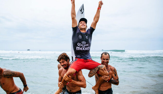 Jack Robinson being chaired to the beach