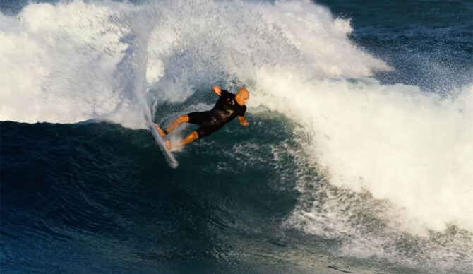 Kelly Slater surfing D Bah on a twin fin surfboard