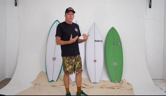 Pyzel standing in front of the Tiger family of surfboards