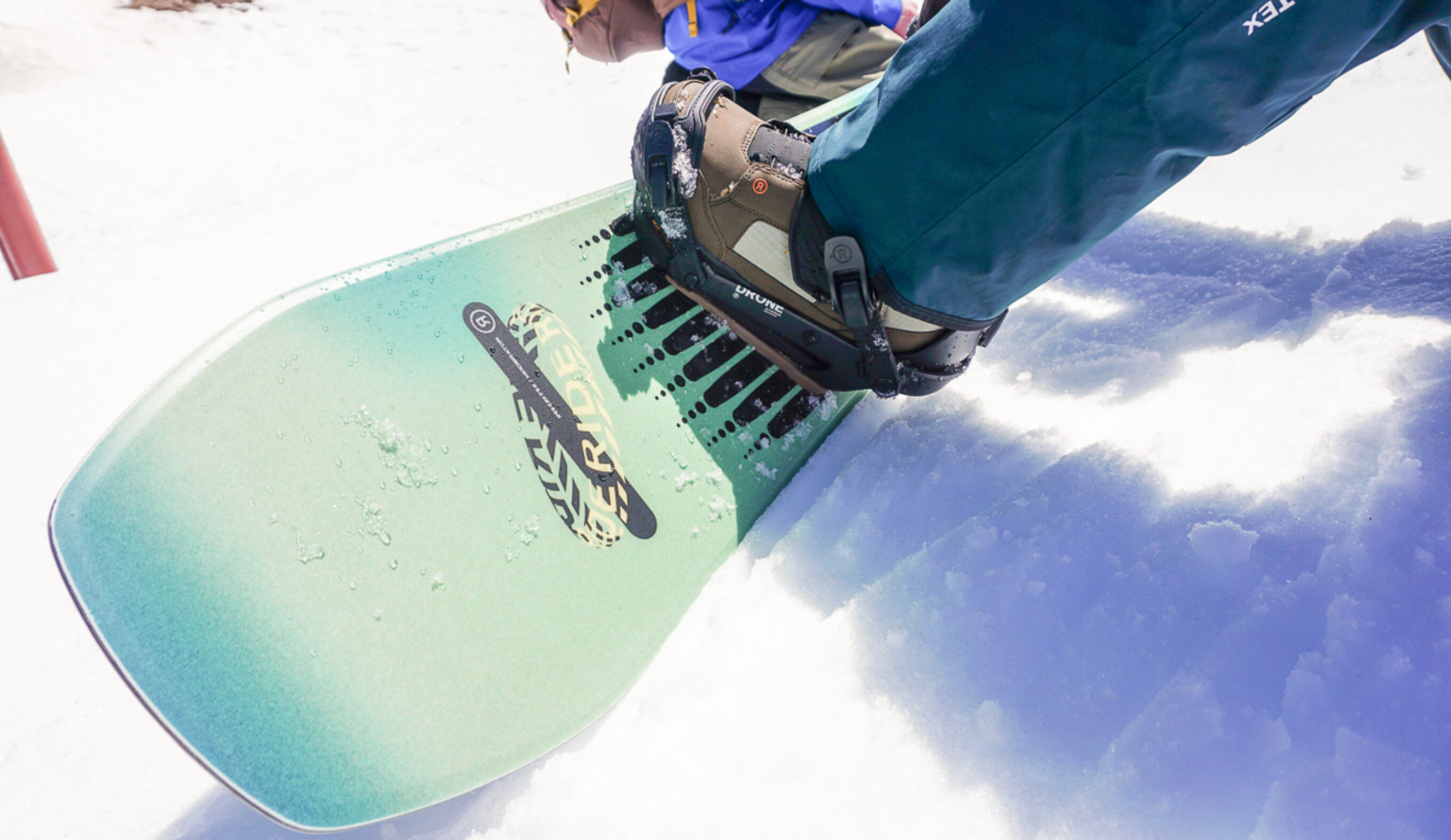 closeup of snowboard nose and boot and binding