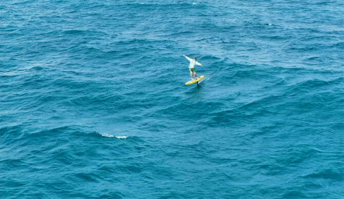 Josh Ku SUP hydrofoiling across the Bali Strait