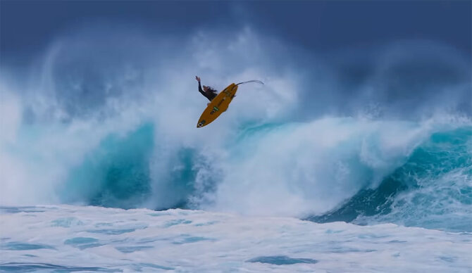 Matt Meola doing an air on a surfboard in Maui