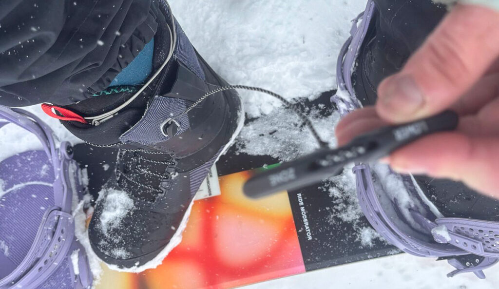 woman lacing a snowboard boot