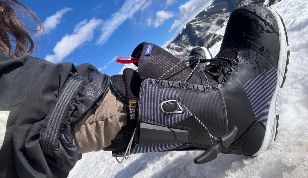 putting on women's snowboard boots