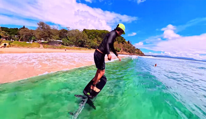 Adam Bennets surfing a foil close to shore