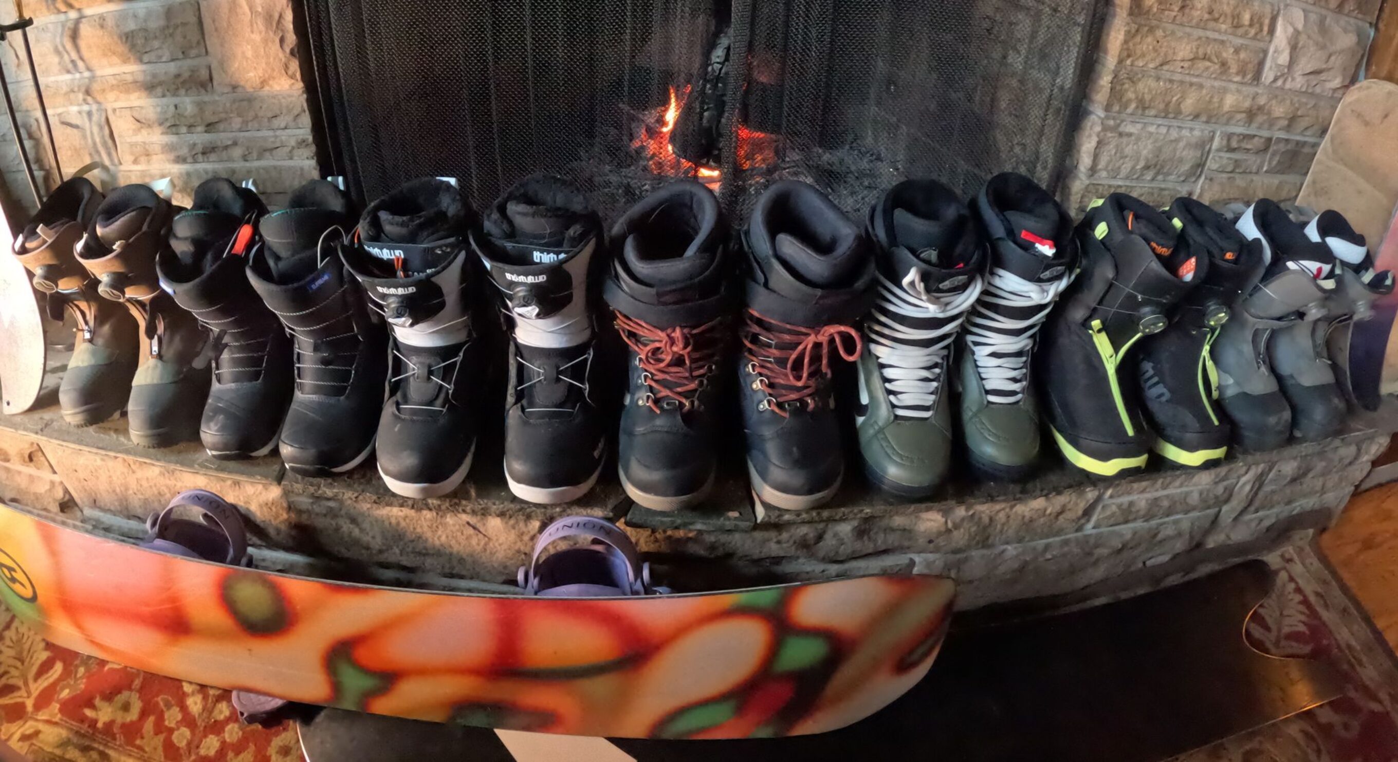 women's snowboard boots lined up on the hearth