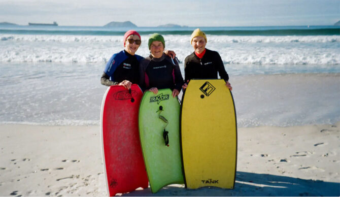 The Granny Grommets on a beach with boogie boards