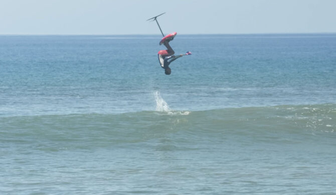 Kai Lenny doing a backflip on a SUP foil