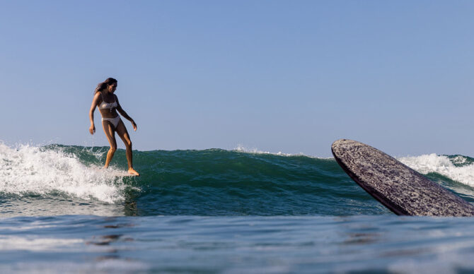 Lex Weinstein surfing on a longboard