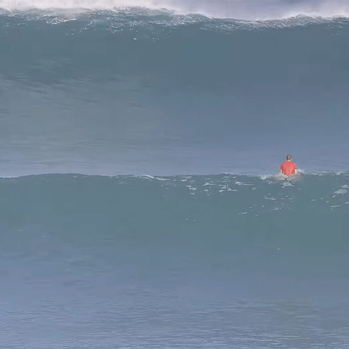 Surfer sitting at Uluwatu