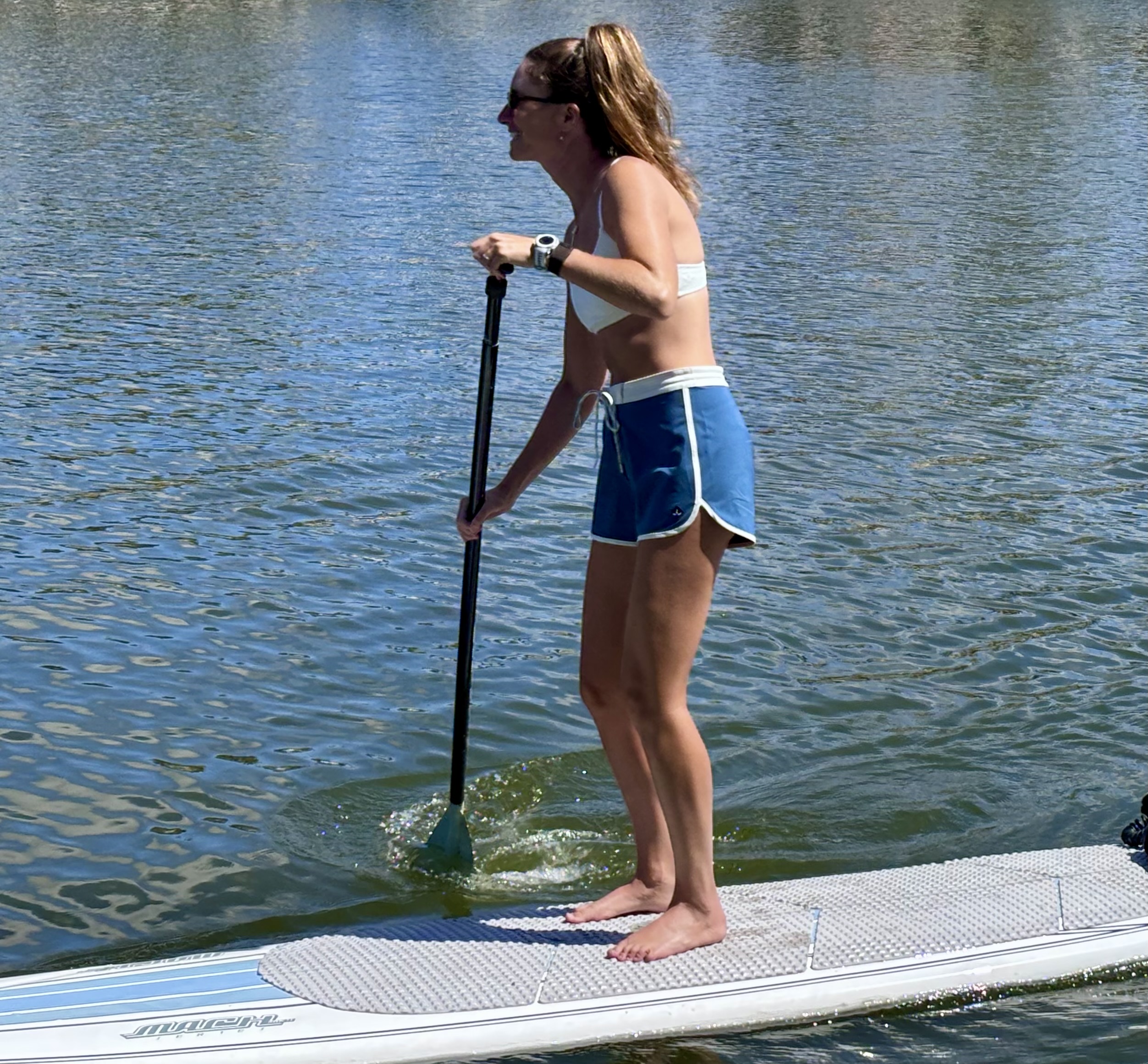 a woman paddle boarding