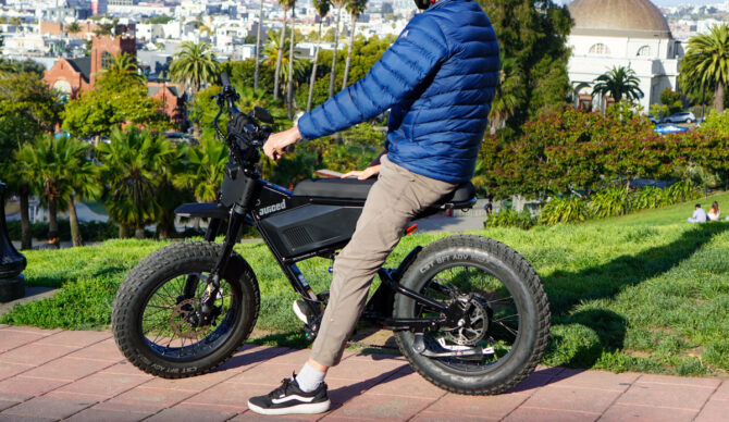 Evan sitting on the Juiced Scrambler ebike